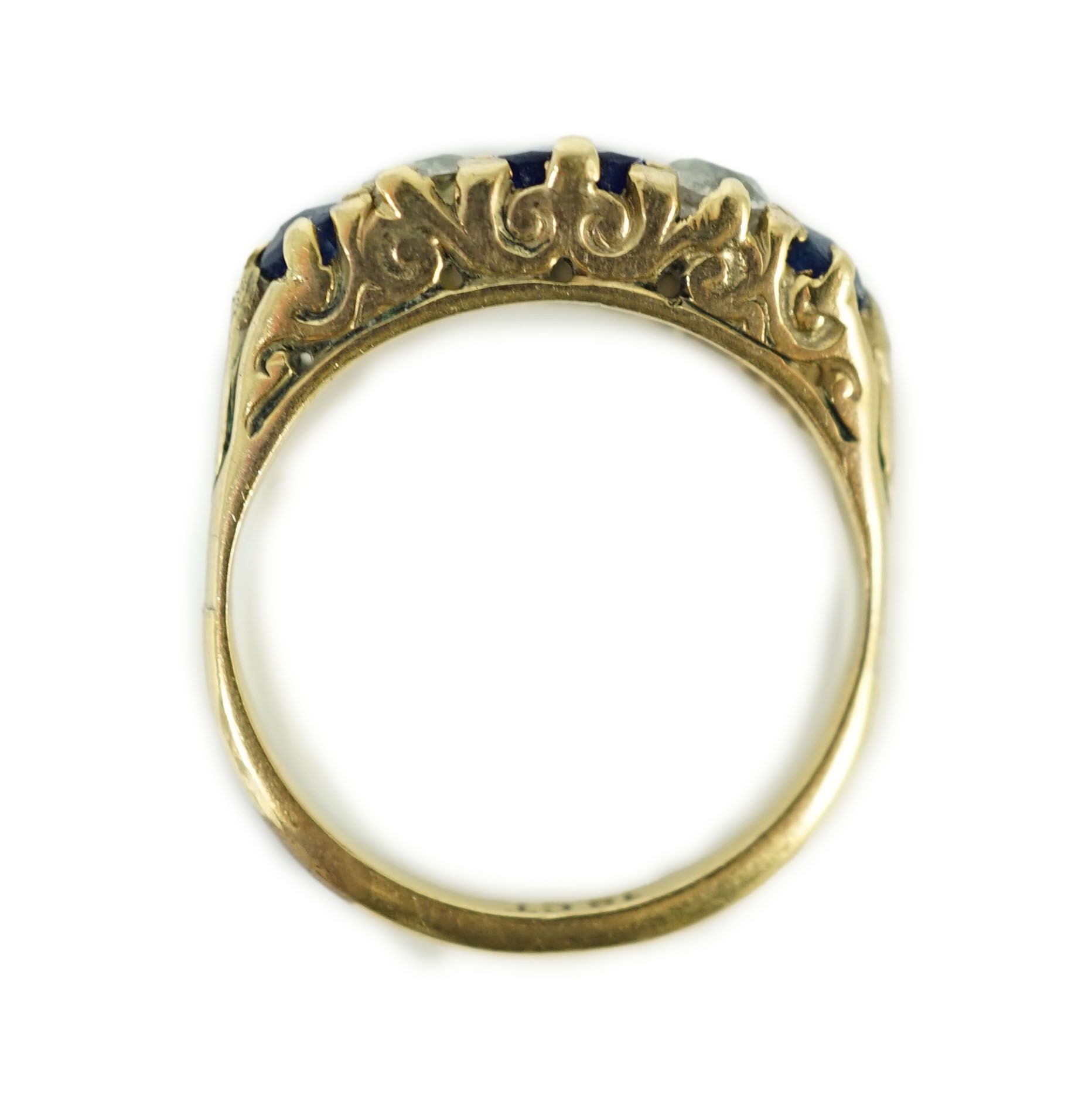 An 18ct gold, graduated three stone sapphire and two stone diamond set half hoop ring